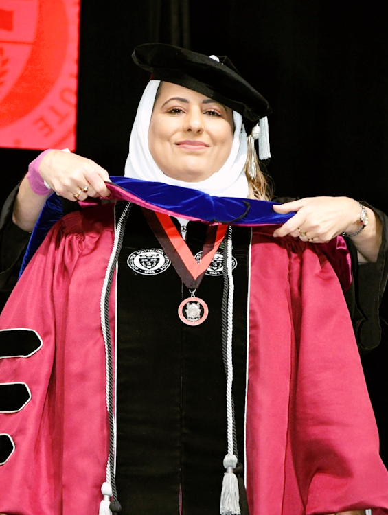 Mallak receives her PhD hood from Elke